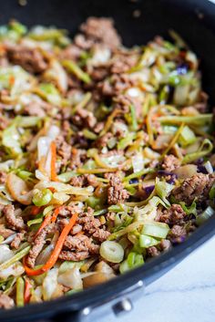 a skillet filled with ground beef and vegetables