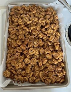 a pan filled with cheetos sitting on top of a stove