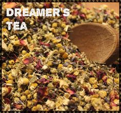 a wooden spoon filled with tea next to a pile of dried flowers