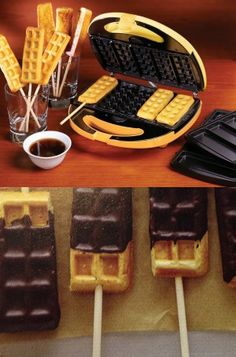 some waffles and chocolate are on sticks next to a plate with syrup in it