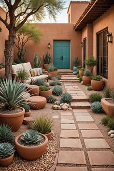 an outdoor courtyard with potted plants and stone walkway leading to a blue front door