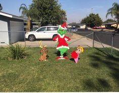 the grinch is standing in the yard with two other characters