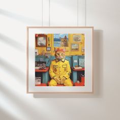 a cat sitting on top of a chair in front of a wall with pictures hanging above it