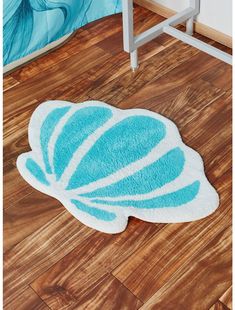 a blue and white bath mat on the floor