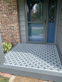 the front porch is decorated with cement tiles