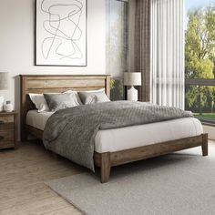 a bedroom with a bed, dressers and window overlooking the trees in the background