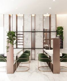 an elegant dining room with marble walls and green velvet chairs in the center, along with potted plants