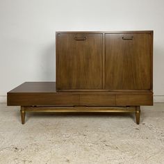 a large wooden cabinet sitting on top of a white floor