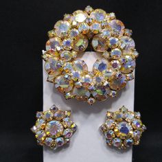 *Description: This is a beautiful aurora borealis rhinestone floral brooch and matching earrings set from the 1960s. The brooch has two rivets meaning the front of the brooch is a second piece which has been attached. The pin is a part of the brooch and the design is high quality with characteristics of Weiss or D & E designs. These pieces are unsigned but have designer qualities and would make an excellent addition to your vintage jewelry collection or make a great vintage gift! *Approximate Me Juliana Jewelry, Costume Jewelery, Antique Costume Jewelry, Book Pieces, Floral Brooch, Mid Century Jewelry, Old Jewelry, Butterfly Pendant, Vintage Rhinestone