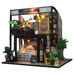 a model of a coffee shop with potted plants