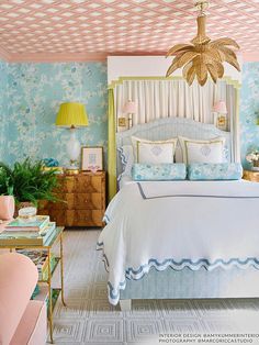 a bedroom decorated in pastel blue and pink