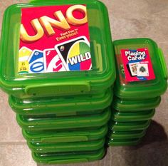 two plastic containers with uno cards on them