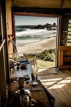 an open door leading to the beach and ocean