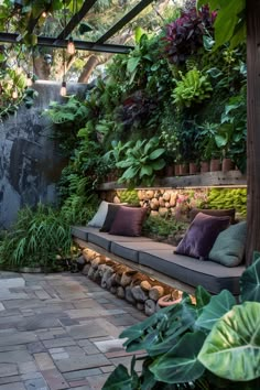 an outdoor seating area with plants and rocks