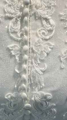 the back of a wedding dress with beading on it