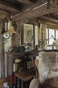 a living room filled with lots of furniture and books on top of a wooden table