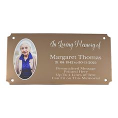 a metal plaque with an image of a woman in blue shirt and white jacket on it