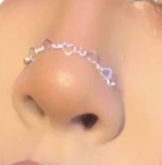 a close up view of a nose with a chain around it's middle part