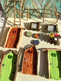 several small wooden boats sitting on top of a white floor next to a wall and window