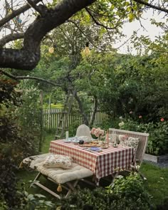 a picnic table in the middle of a garden