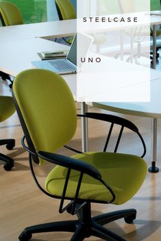 an office chair sitting in front of a white table