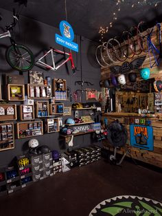 a bike shop with lots of bikes hanging from the ceiling and shelves on the wall