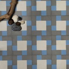 a blue and white tiled floor with rocks on it