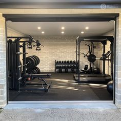 an open garage door showing the gym equipment in it's storage area, with lights on either side