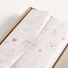 an open box with pink and white designs on it