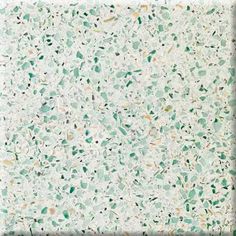 a white counter top with green speckles on it