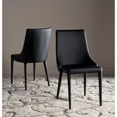 two black chairs sitting on top of a rug