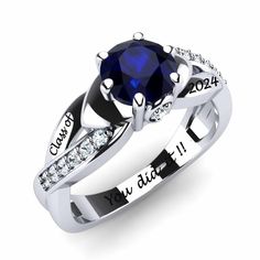 an engagement ring with a blue sapphire stone in the center and diamond accents around it