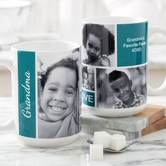 two coffee mugs sitting on top of a table next to marshmallows