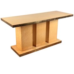 a wooden table with three columns on it