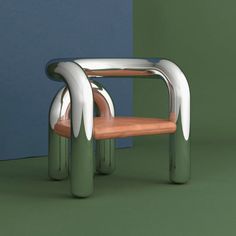 a chair made out of metal and wood in front of a blue wall with green walls