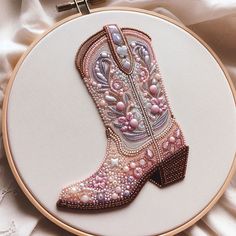 an embroidered cowboy boot with pearls on the inside is shown in this embroidery hoop art project