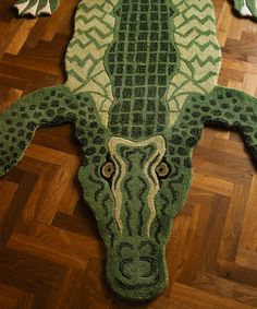 a rug with an animal's head is on the floor in front of a wooden floor