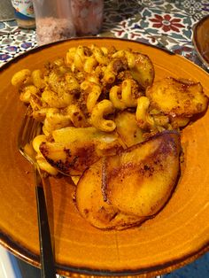 a yellow plate topped with macaroni and cheese