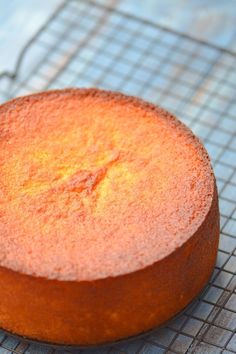 a round cake sitting on top of a cooling rack