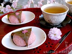 three desserts on plates with tea and flowers in the background