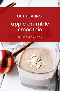 an apple crumble smoothie in a glass with cinnamon sticks