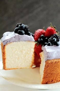 small batch angel food cake with blueberries and raspberries on top, sitting on a white plate