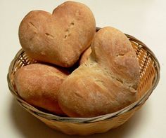 several loaves of bread in a basket on a counter top with a white background