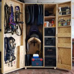 the inside of a wooden storage cabinet with many items in it