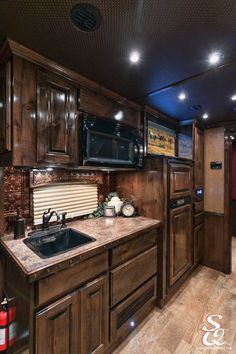 a kitchen with wooden cabinets and granite counter tops