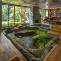 a living room filled with lots of furniture and green moss growing on the floor next to a fire place