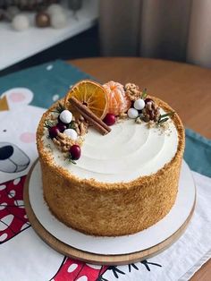 a cake with white frosting and fruit on top