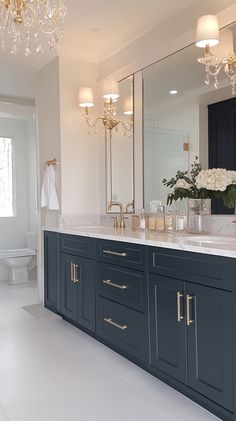 a bathroom with blue cabinets and white tile flooring