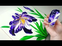 someone is painting flowers with acrylic paint on the paper and then using it