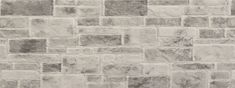 a white brick wall that is made out of grey bricks